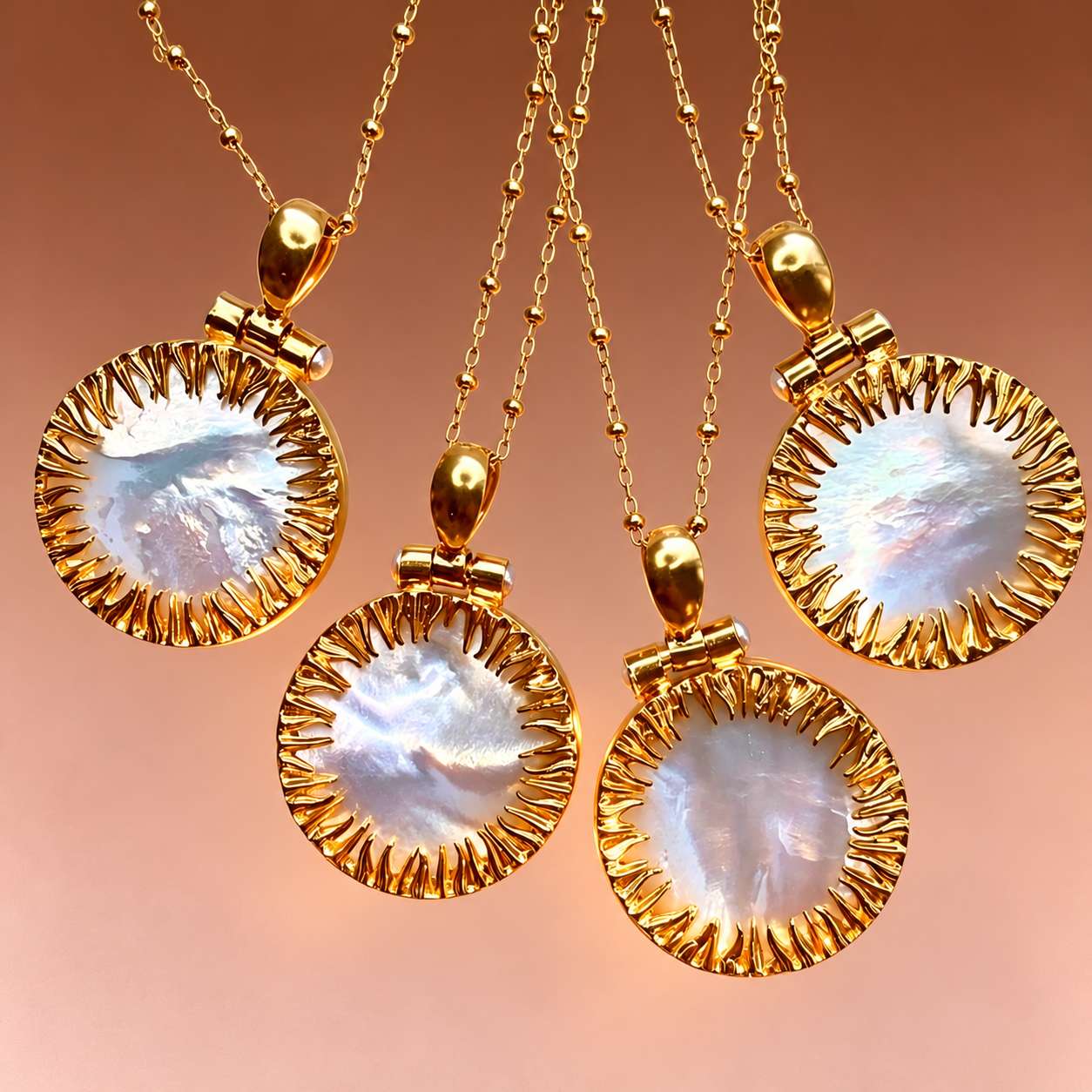 Four round mother-of-pearl pendant necklaces showing natural variations in the shell