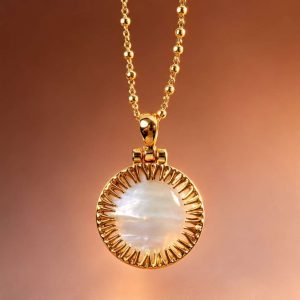 Round mother-of-pearl pendant with gold-tone sunburst frame on a gold-tone chain