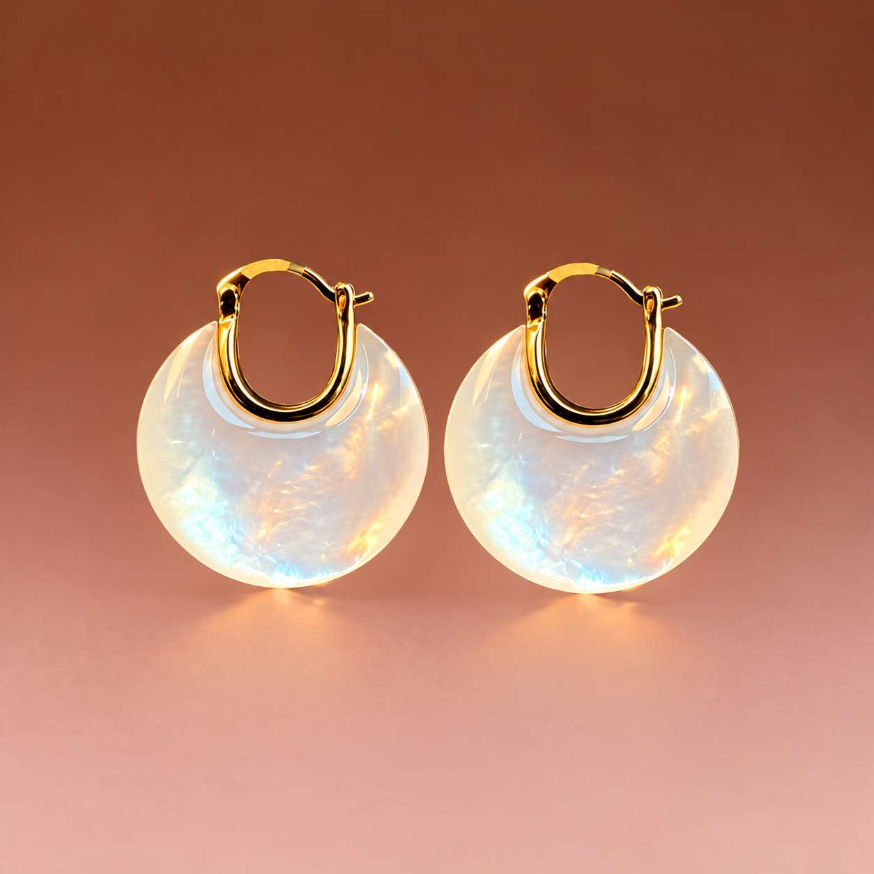 Round mother-of-pearl disc earrings with gold-tone hoop fittings